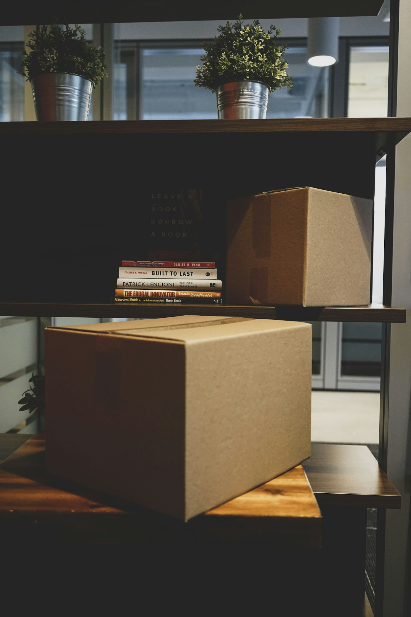 Cardboard moving boxes on office shelving